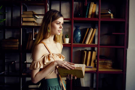 beautiful woman with a book in the hands of a cafe recreationの写真素材
