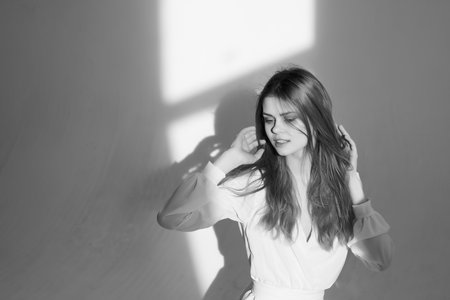 pretty woman in dress black and white photo posing studioの写真素材