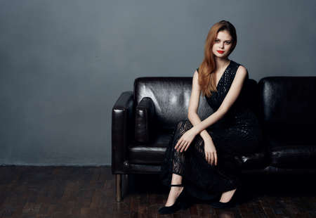 pretty woman in black dress posing glamor dark background modelの写真素材