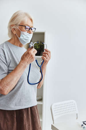 elderly woman stethoscope treatment hospital healthの写真素材