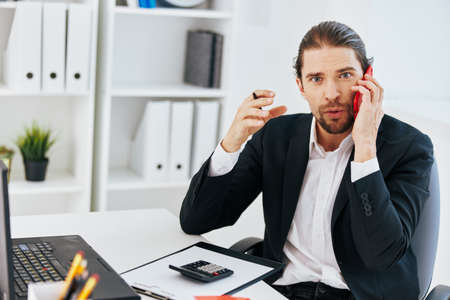 office worker at the desk documents communication by phone Lifestyleの写真素材