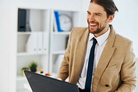 fashionable man in the office with a laptop technologiesの写真素材