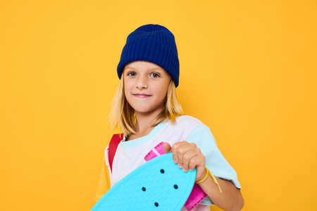 schoolgirl with a skateboard on his head Childhood lifestyle concept