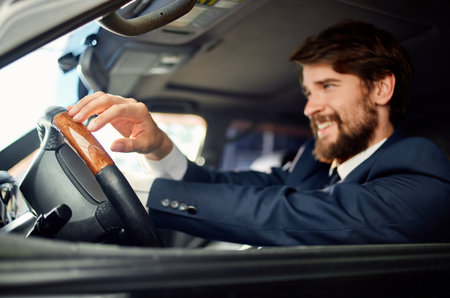 businessmen in a suit in a car a trip to work communication by phone