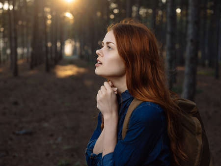 red-haired woman in forest nature travel walk freedomの写真素材