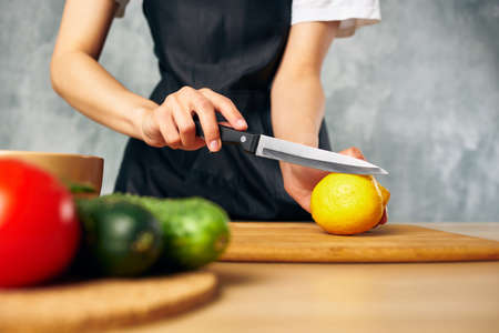 housewife on the kitchen cutting vegetablesの写真素材