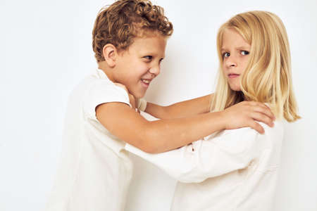 Two children boy and girl little cheerful cheery friends light backgroundの写真素材