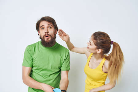 young couple in multicolored t-shirts facial skin care shavingの写真素材