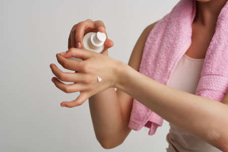 applying cream on the skin moisturizing cosmetologyの写真素材