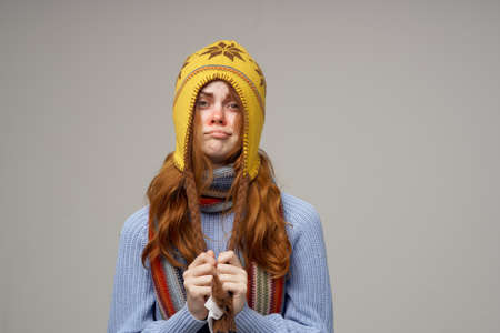 red-haired woman cold handkerchief close-upの写真素材
