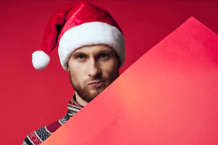 emotional man in a christmas red mockup poster studio posingの写真素材