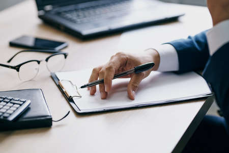 businessmen sitting at a desk in front of a laptop finance technologiesの写真素材