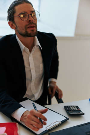 businessman documents work office laptop technologiesの写真素材