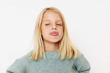 emotional girl with blond hair posing studioの写真素材