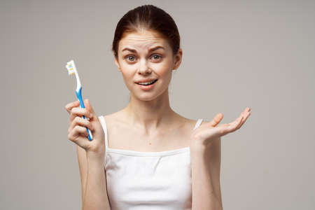 cheerful woman toothpaste brushing teeth dental health light background