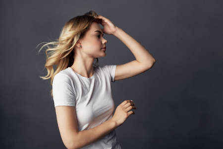 blonde attractive look makeup posing dark backgroundの写真素材