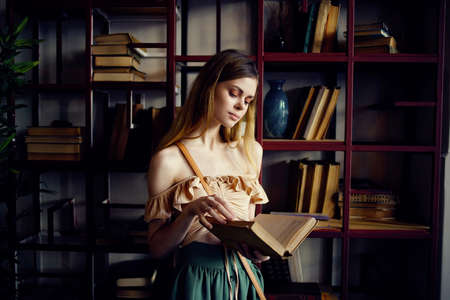 cheerful woman reading a book in a cafe recreationの写真素材