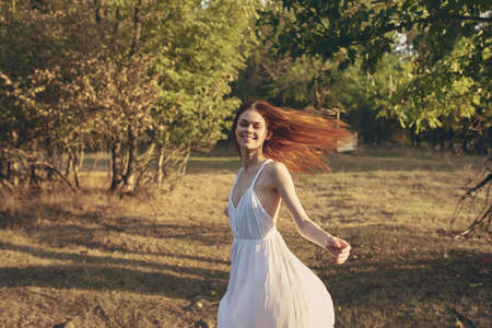 woman in white dress Outdoors summer nature strollの写真素材