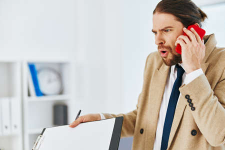 fashionable man holding a phone telephone office technologiesの写真素材