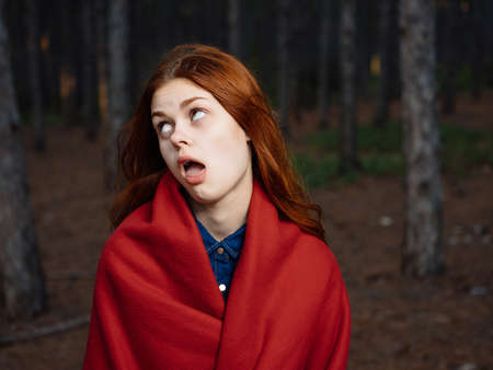 woman in forest with red plaid travel posingの写真素材