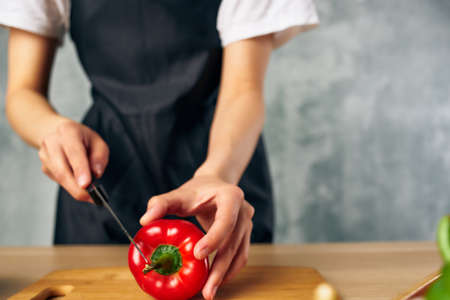 Woman in black apron Cooking healthy eating cutting boardの写真素材