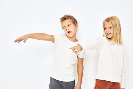 cheerful children dance little cheerful cheery friends light backgroundの写真素材