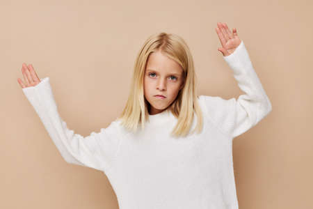 Beautiful little girl gestures with his hands kids lifestyle conceptの写真素材