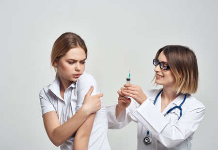 nurse syringe in hand treatment isolated backgroundの写真素材