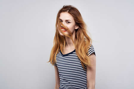 beautiful woman in a striped t-shirt red lips gesture with his hands model studioの写真素材