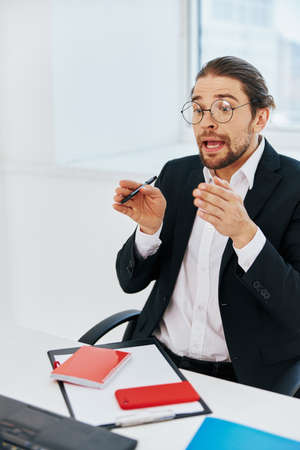 man in a suit phone laptop work emotions lifestyleの写真素材