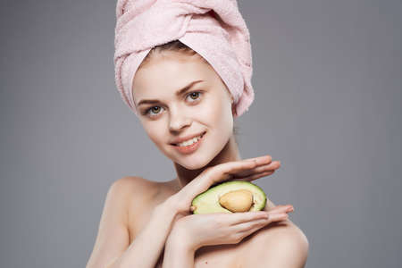 pretty woman bare shoulders skin care avocado posing close-up