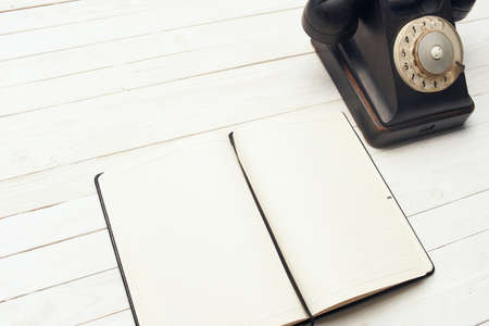 retro telephone he communication office notepad wooden background objectの写真素材
