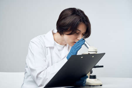 woman laboratory assistant microscope biology research scienceの写真素材