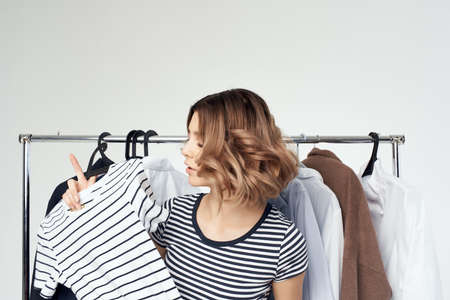 pretty woman clothes hanger shopping light background