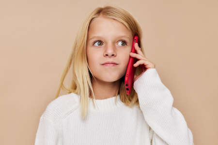 happy cute girl talking on the phone technology posing studio
