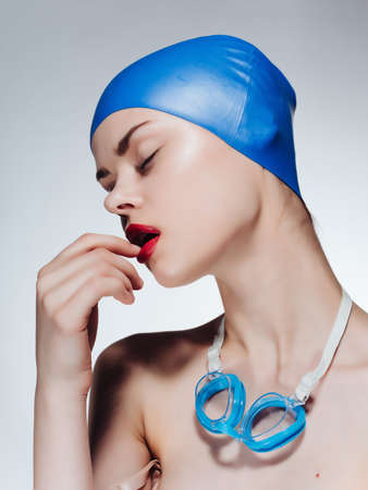woman with bare shoulders swimming cap red lips posing sportsの写真素材