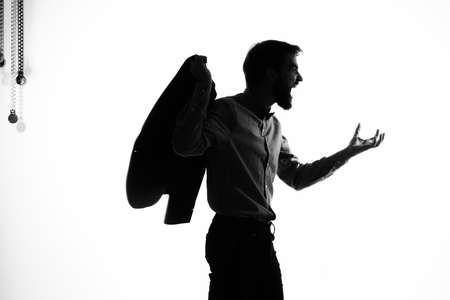 The man in a suit Secret agent with a gun in the hands of a crime posing studioの写真素材