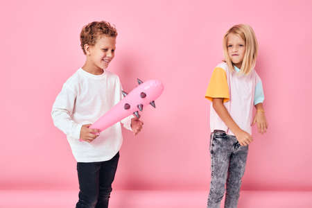 a boy with a toy baton next to a girl playingの写真素材