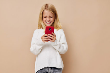 happy cute girl talking on the phone technology on a beige background