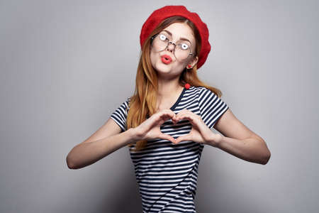 cheerful woman in red hat posingの写真素材