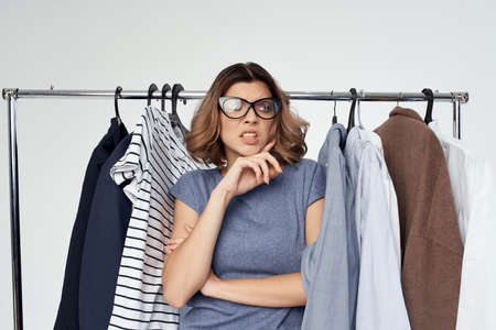 cheerful woman selection of clothes near the wardrobe studio lifestyleの写真素材