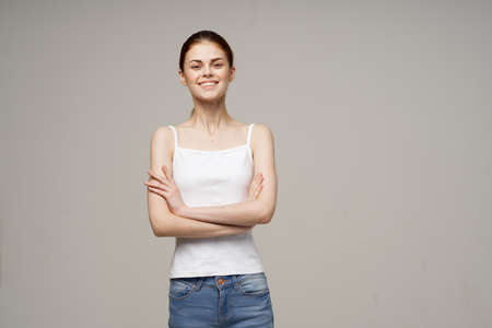 Joyful Woman in White T-shirt Joints Warm Upの写真素材