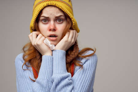 woman neck scarf with a hat on his head light backgroundの写真素材