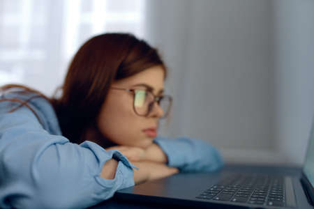 woman in front of laptop fatigue work nervesの写真素材