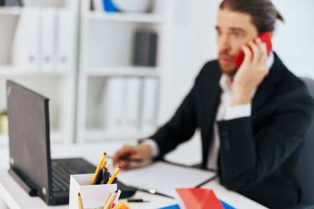 office worker at the desk documents communication by phone Lifestyleの写真素材