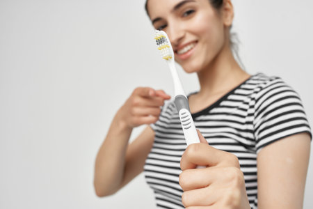 cheerful woman hygiene teeth cleaning care health light backgroundの写真素材