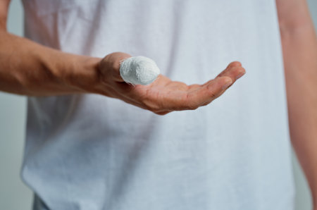 male patient in a white T-shirt with a bandaged hand hospital medicineの写真素材