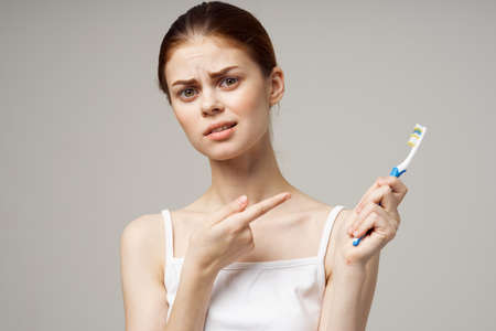 cheerful woman in white t-shirt dental hygiene health care studio lifestyle
