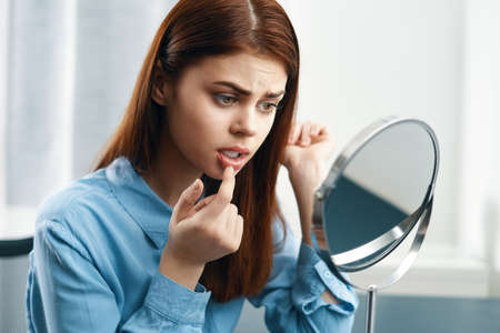 woman looking in the mirror cosmetics personal careの写真素材