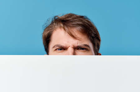 handsome man white sheet presentation advertising blue backgroundの写真素材